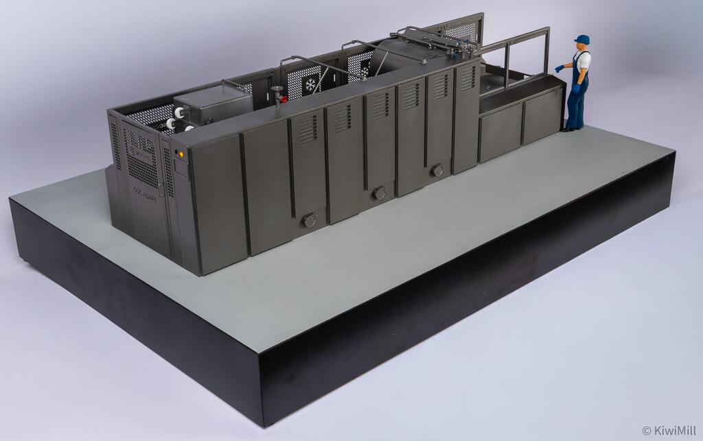 Rear three-quarter view of the cooking line model with louvered access doors and a worker figure at the far end